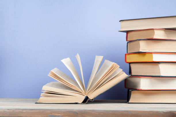 istock Open book, hardback books on wooden table. Education background. Back to school. Copy space for text. 888663812