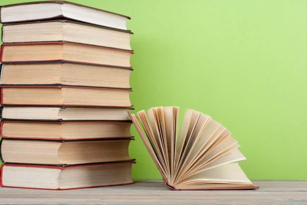 istock Open book, hardback books on wooden table. Education background. Back to school. Copy space for text. 888666136