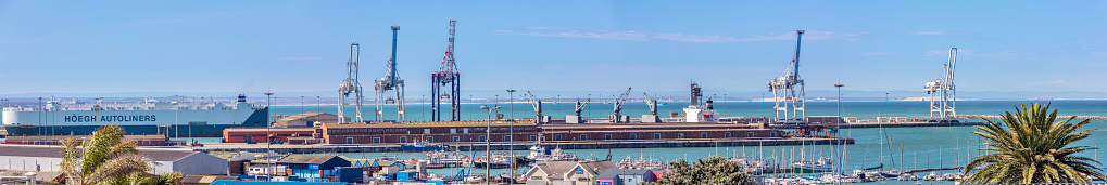 Vehicle shipping freight liner at the docks in Port Elizabeth panoramic view of the lifting cranes and boat club.