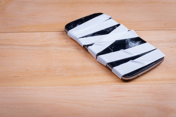 istock The phone with cracks on the screen is rewound on the right 888672236