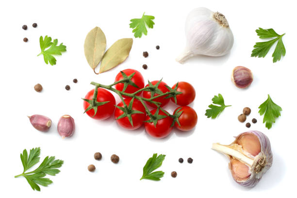 istock cherry tomato, garlic and spices isolated on white background. top view 888674514