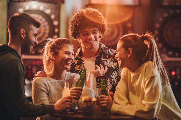 istock Young cheerful friends communicating after playing darts in a bar. 888678648