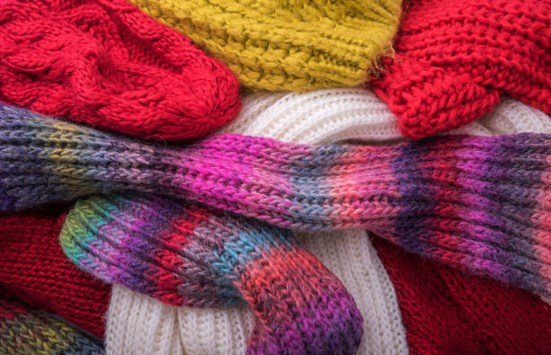 istock Warm winter clothes. Caps and scarves. 888681138