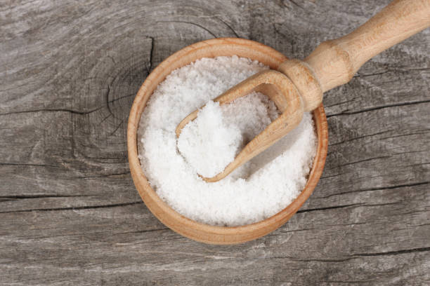 istock salt on wood plate on old wooden table. Top view 888685080