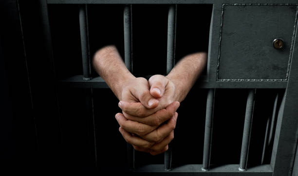 istock Jail Cell Door And Hands 888688388