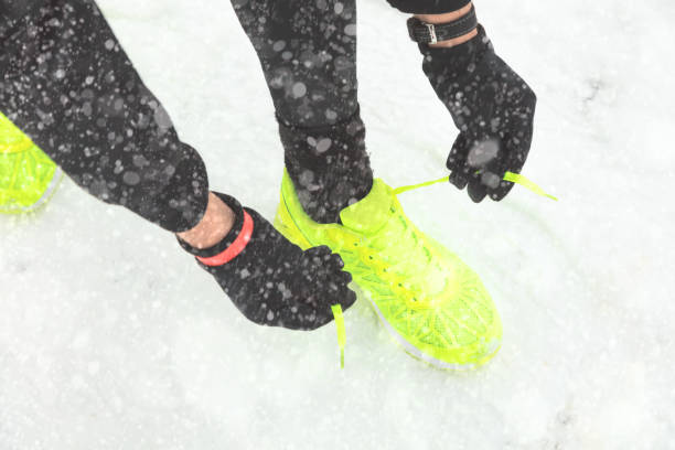 istock Tying running shoes on the freezing snow. 888691986