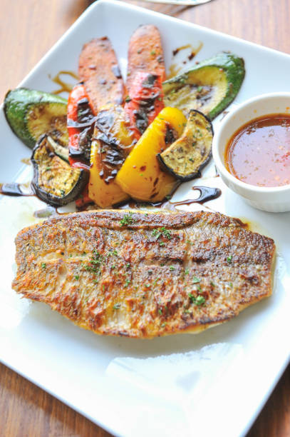 istock Grilled fish cutlet with vegetables 888692740