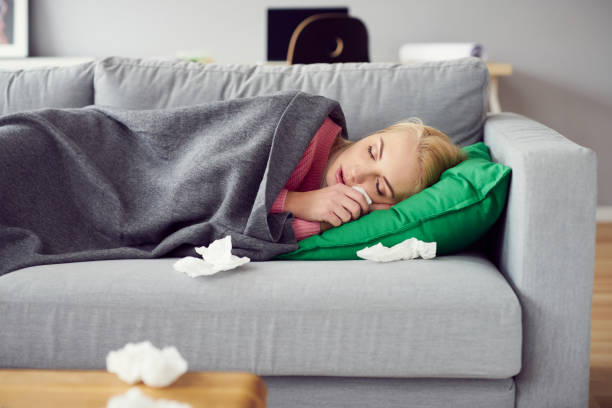 istock Sick woman sleeping on the sofa in living room 888698108