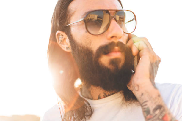 istock Hipster tattooed rebel guy using mobile phone 888698712