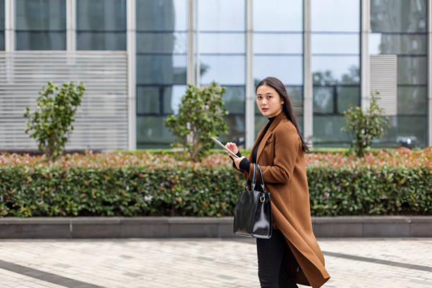 istock businesswoman using digital tablet near by office building 888699244