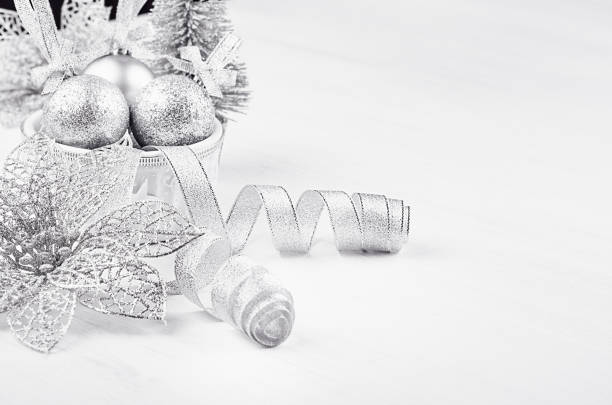 istock Christmas silvery decorations on white soft wood background. 888715438