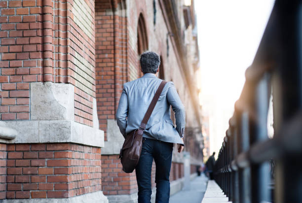 istock Mature businessman walking in a city. 888723270