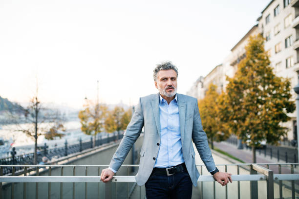 istock Mature businessman in a city. 888729360