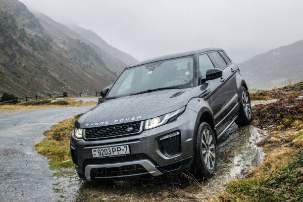 Range Rover Evoque Davos, Switzerland - October 3, 2017: Range Rover Evoque travels across Switzerland and European Alps to northern Italy. Photo taken in the Alps near Davos and on Umbrail pass. Range Rover Evoque is a compact SUV with a high functionality and great potential for long road travels. evoque stock pictures, royalty-free photos & images