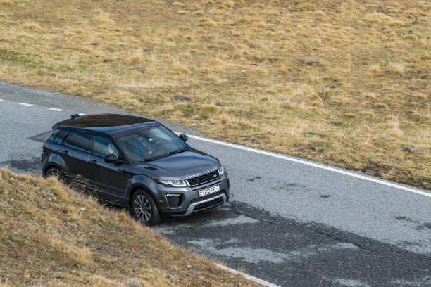 Range Rover Evoque Davos, Switzerland - October 3, 2017: Range Rover Evoque travels across Switzerland and European Alps to northern Italy. Photo taken in the Alps near Davos and on Umbrail pass. Range Rover Evoque is a compact SUV with a high functionality and great potential for long road travels. evoque stock pictures, royalty-free photos & images