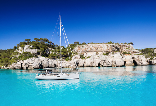 Beautiful bay with sailing boat, Menorca island, Spain