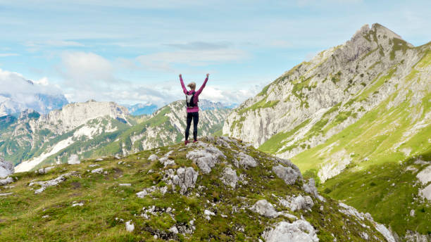 istock Female runner standing on mountain trail 888739248