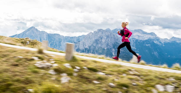 istock Woman running on road high in mountains 888739298