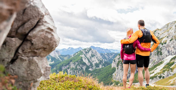 istock Female and male runners standing on mountain 888739400