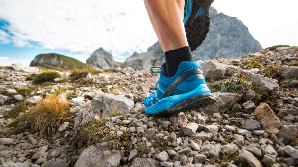istock Male runner running across meadow high in mountains 888739528