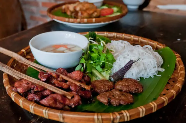 Made from rice flour, bun cha is eaten cold with warm grilled pork meat on skewers. It is normally eaten with an abundance of herbs including mint and coriander. The dipping sauce is normally sweetened.
