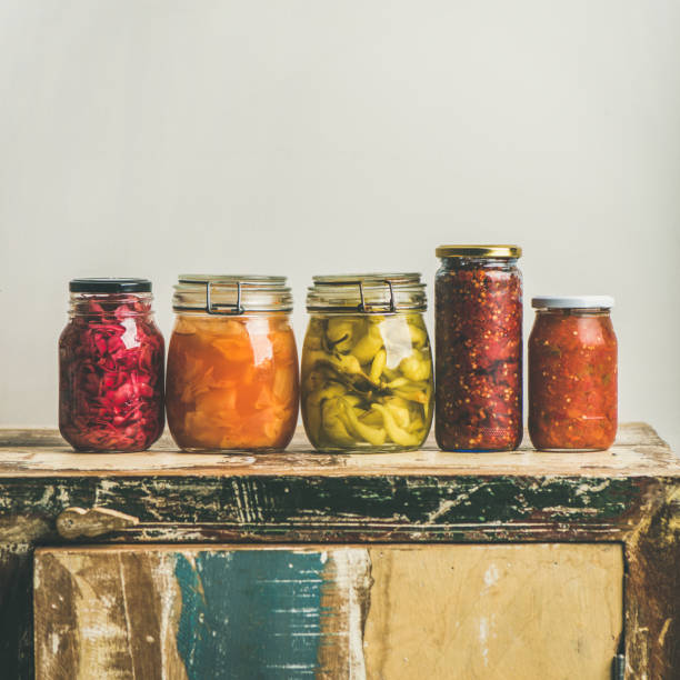 istock Autumn pickled vegetables in jars placed in line, square crop 888751802