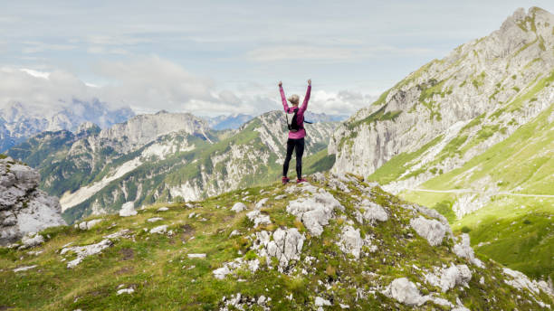 istock Female runner standing on mountain trail 888752654