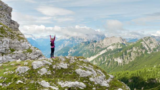 istock Female runner standing on mountain trail 888752664