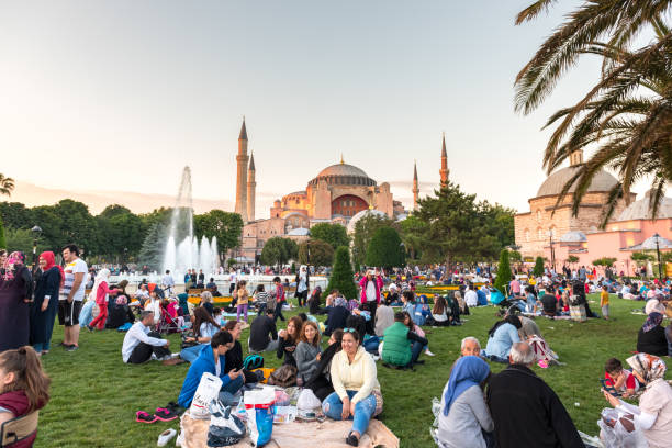 Muslim people who are fasting wait for the adhan and evening meal Muslim people who are fasting wait for the adhan (ezan) and evening meal (Iftar) in Ramadan month in Sultan Ahmet Park, Istanbul,Turkey.ISTANBUL,TURKEY,JUNE 11,2017 azan stock pictures, royalty-free photos & images