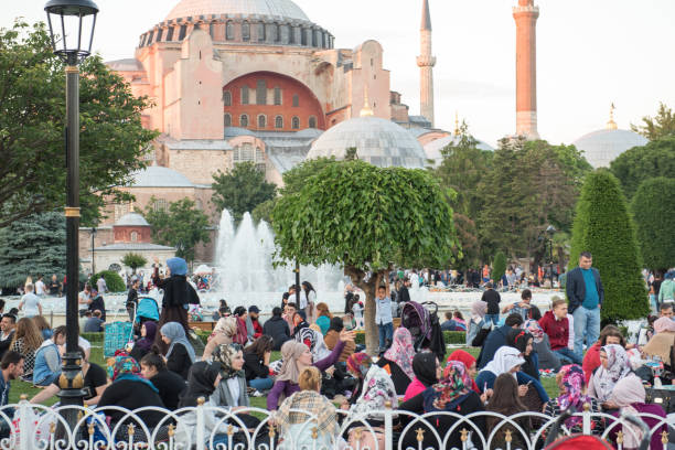 Muslim people who are fasting wait for the adhan and evening meal Muslim people who are fasting wait for the adhan (ezan) and evening meal (Iftar) in Ramadan month in Sultan Ahmet Park, Istanbul,Turkey.ISTANBUL,TURKEY,JUNE 11,2017 azan stock pictures, royalty-free photos & images