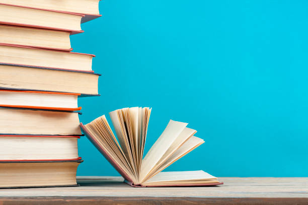 istock Open book, hardback books on wooden table. Education background. Back to school. Copy space for text. 888763366
