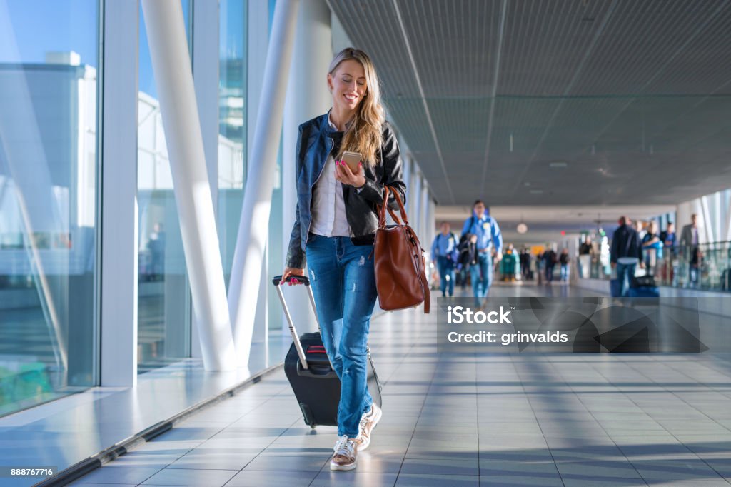 Mujer feliz viajando y caminando en el aeropuerto - Foto de stock de Aeropuerto libre de derechos