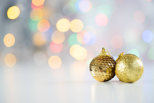 istock christmas gift with balls bow bright background. Studio shot 888772074