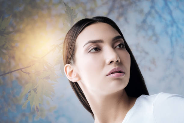 istock Pretty young woman looking romantic while standing in a garden 888797120