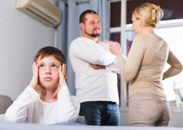 istock unhappy boy at home while parents quarreling 888797790