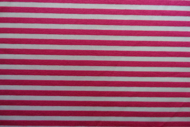 istock Pink fabric with horizontal white stripes from above 888801416