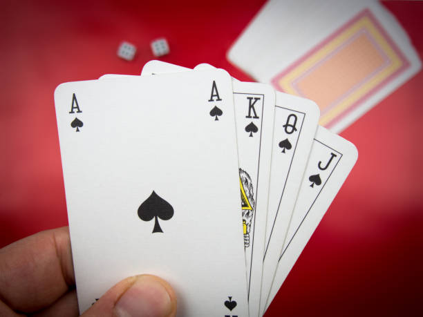 istock hand-held poker playing cards and two playing tricks 888804690