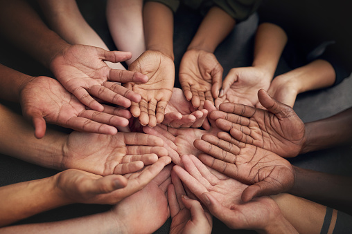 High angle shot of a group of unrecognizable people's hands out with their palms open