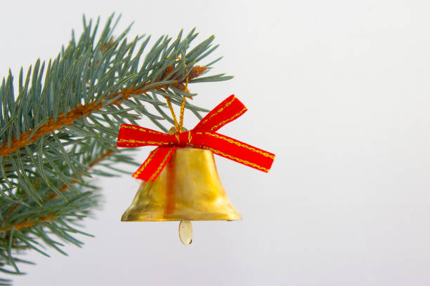 istock Bell with red bow on branch of Christmas tree 888804848