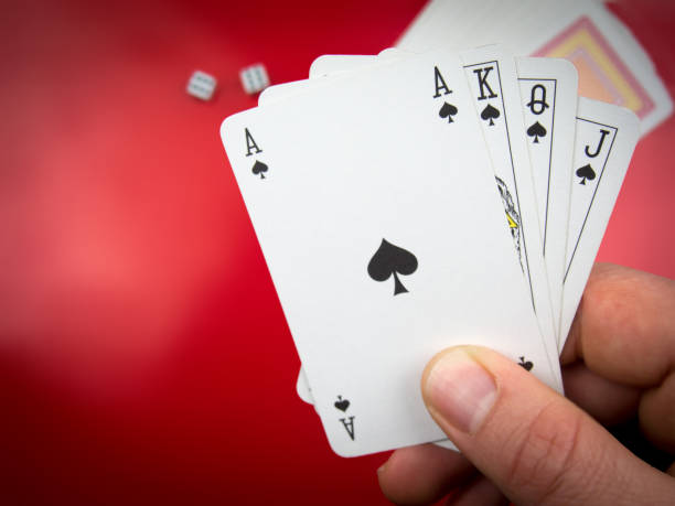 istock hand-held poker playing cards and two playing tricks 888804850