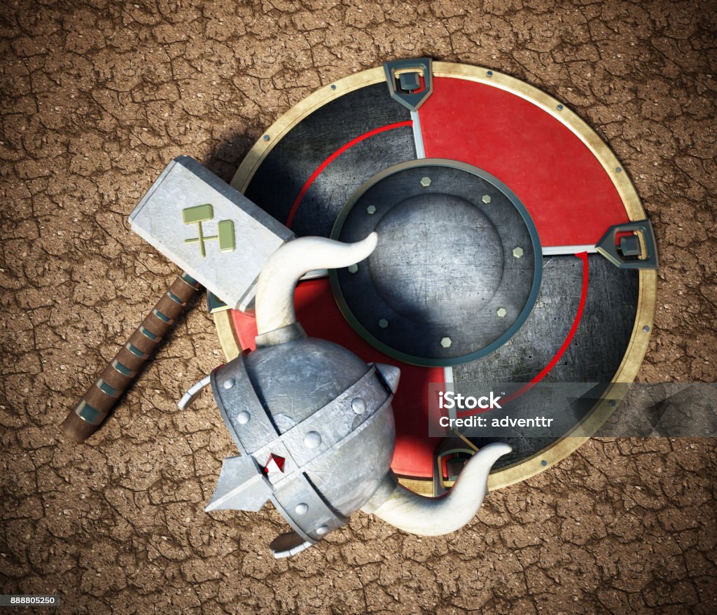 Viking helmet, round shield and hammer on cracked soil Viking helmet, round shield and hammer on cracked soil. Viking Helmet Stock Photo