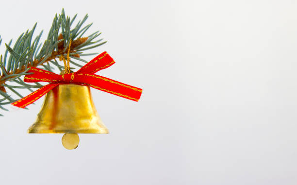istock Bell with red bow on branch of Christmas tree 888811582