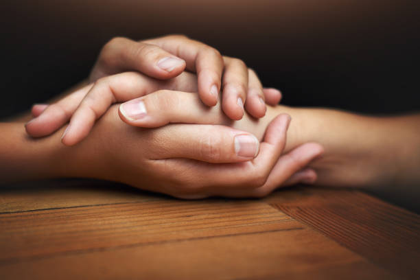 We can get through this together Cropped shot of two unrecognizable people holding hands in comfort family holding hands stock pictures, royalty-free photos & images