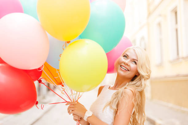 istock smiling woman with colorful balloons 888813532
