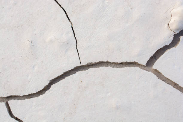 istock Brown color dry cracked muddy earth 888825910