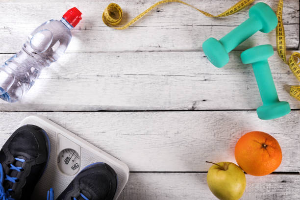 istock workout items on white wooden gym floor with copy space. top view 888840136