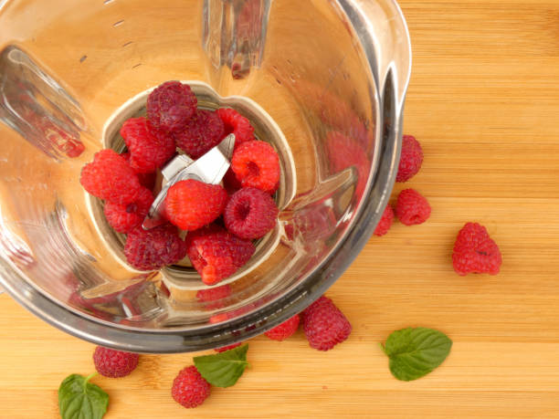 istock Raspberries in the blender on wooden plank 888841902
