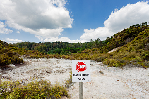 A warning sign is designed to protect visitors from geothermal sources and danger at the  Whakarewarewa park witch is a geothermal area within Rotorua city in the Taupo Volcanic Zone of New Zealand.