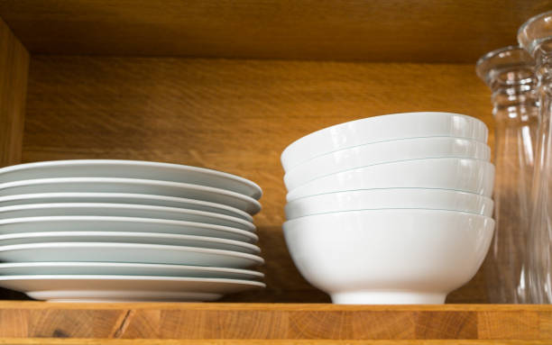 istock white dishes and glasses in a kitchen shelf 888847136