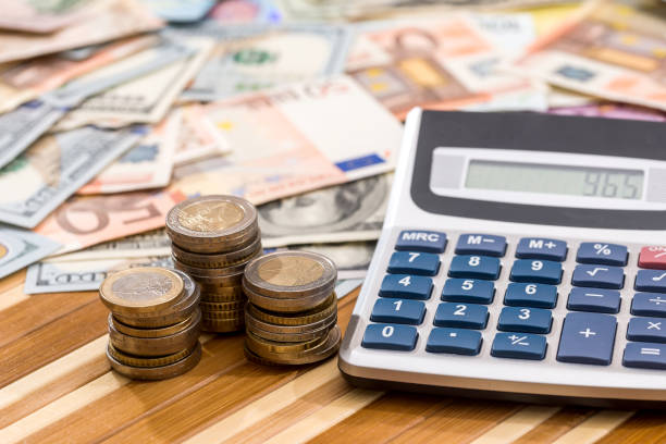istock dollar and euro banknotes with coin and calculator. 888851712